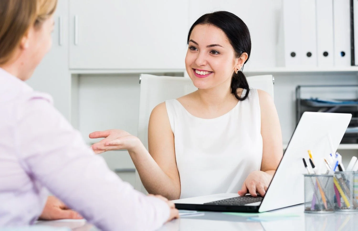 Happy recruiter and candidate smiling at each other across a table, representing successful and seamless hiring in Pune